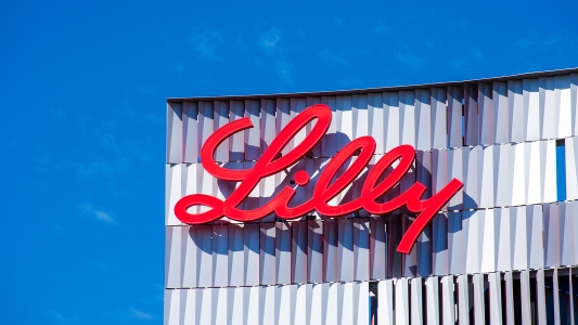 a large red Eli Lilly sign on the side of a building.