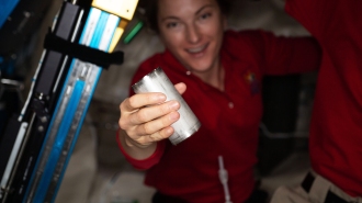 A woman engaging in water recycling on the ISS.